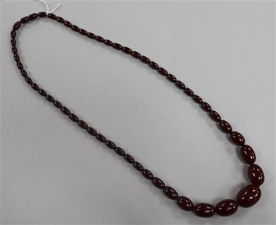 A single strand simulated cherry amber necklace, gross weight 61 grams, 76cm.